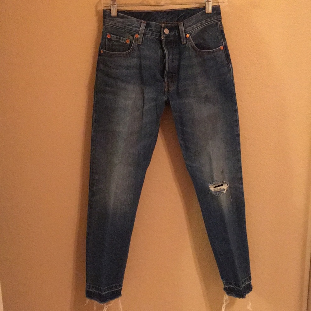 Worn look frayed blue jeans